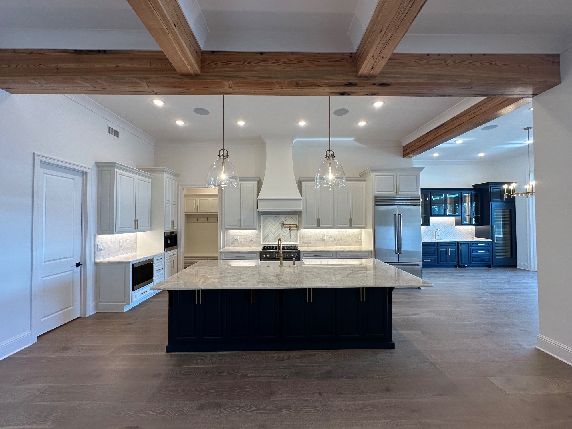Gourmet kitchen with exposed beams and custom island